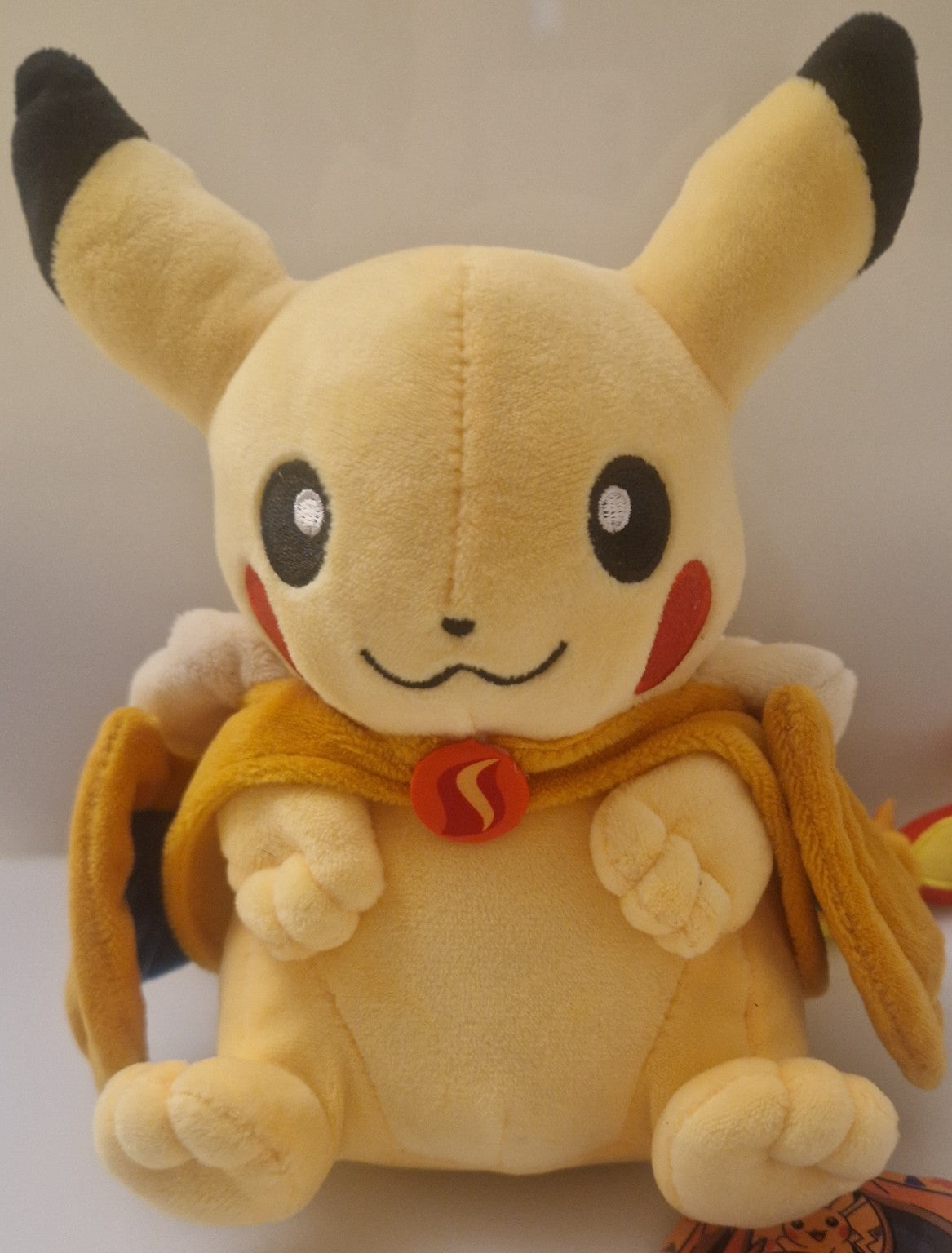 Front view of Pikachu plush with Charizard-style hood removed