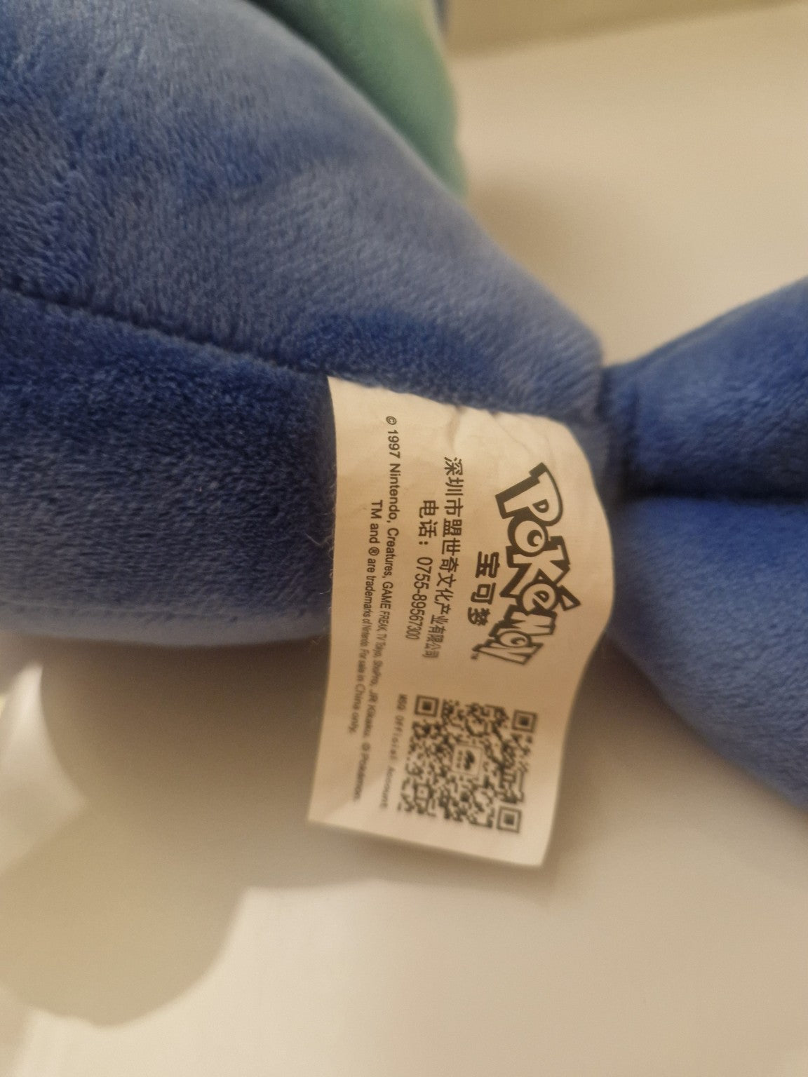 Official Pokémon licensing label attached to Popplio plush soft toy