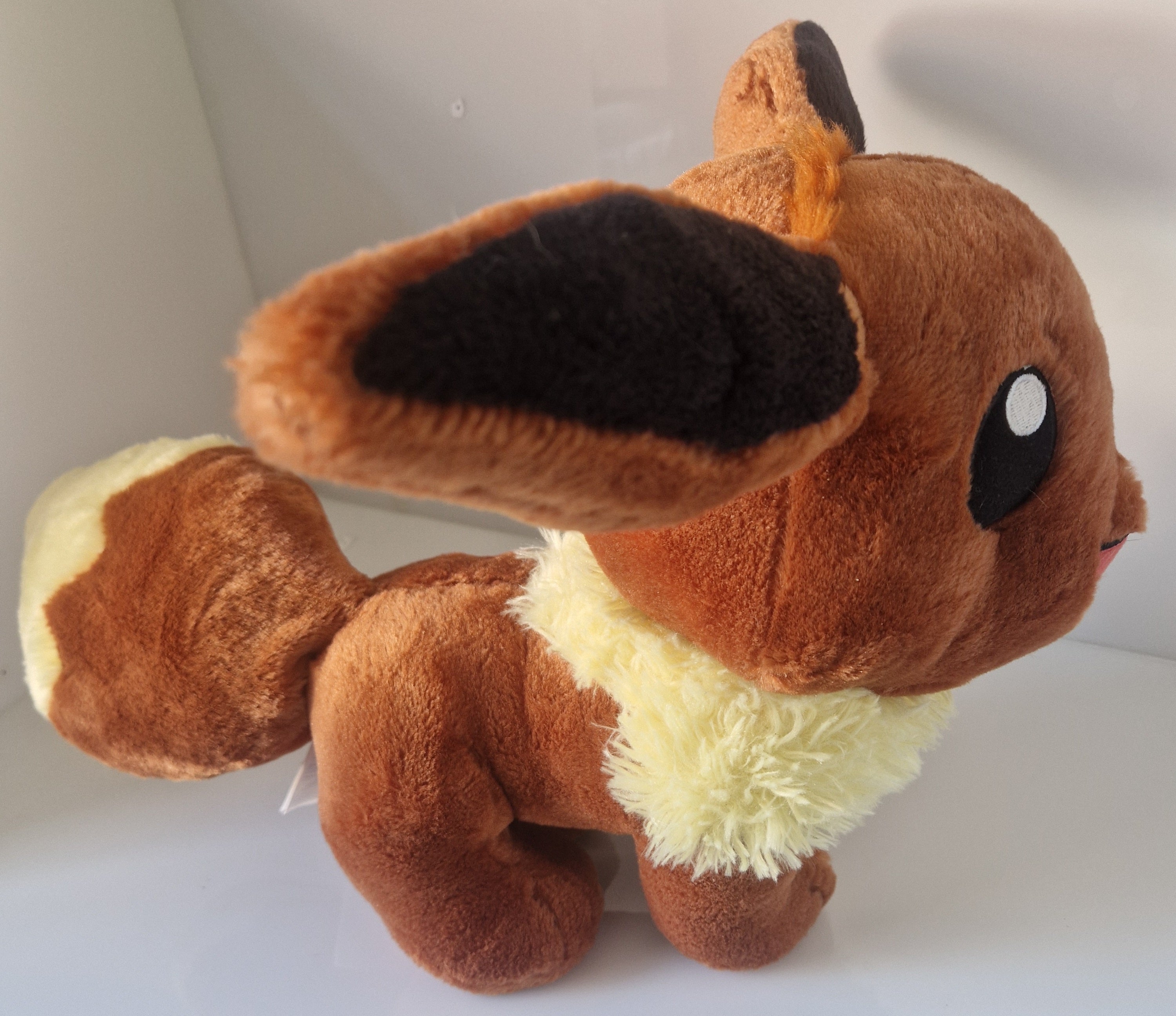 Side view of official Pokémon Eevee Build-A-Bear Workshop plush