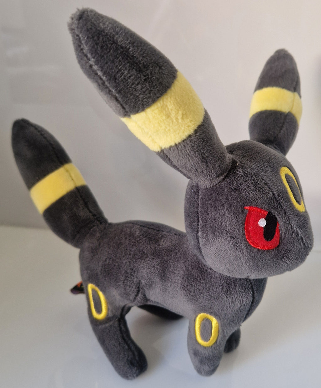 Side view of official Pokémon Umbreon plush soft toy