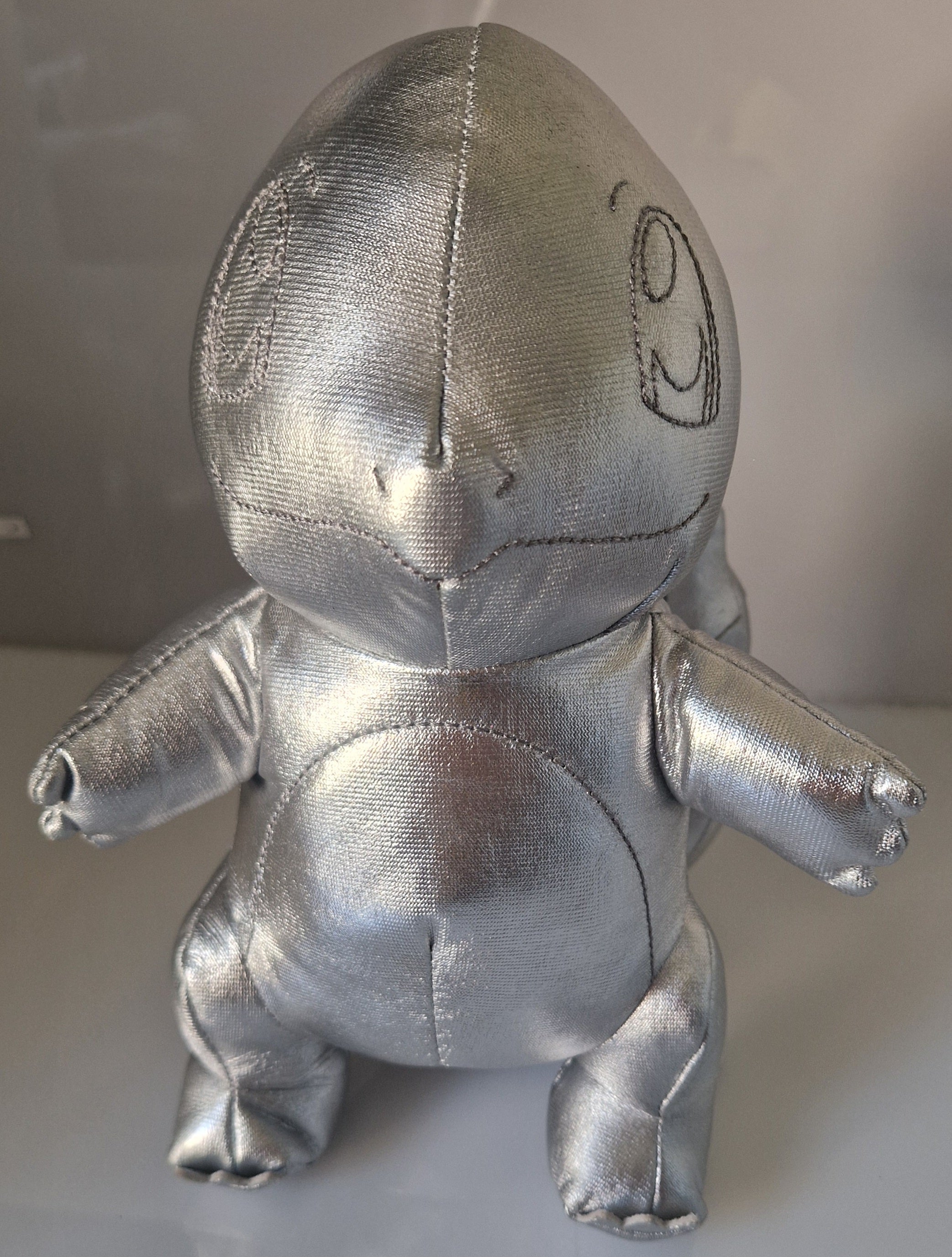 Front view of official silver metallic Pokémon Charmander plush