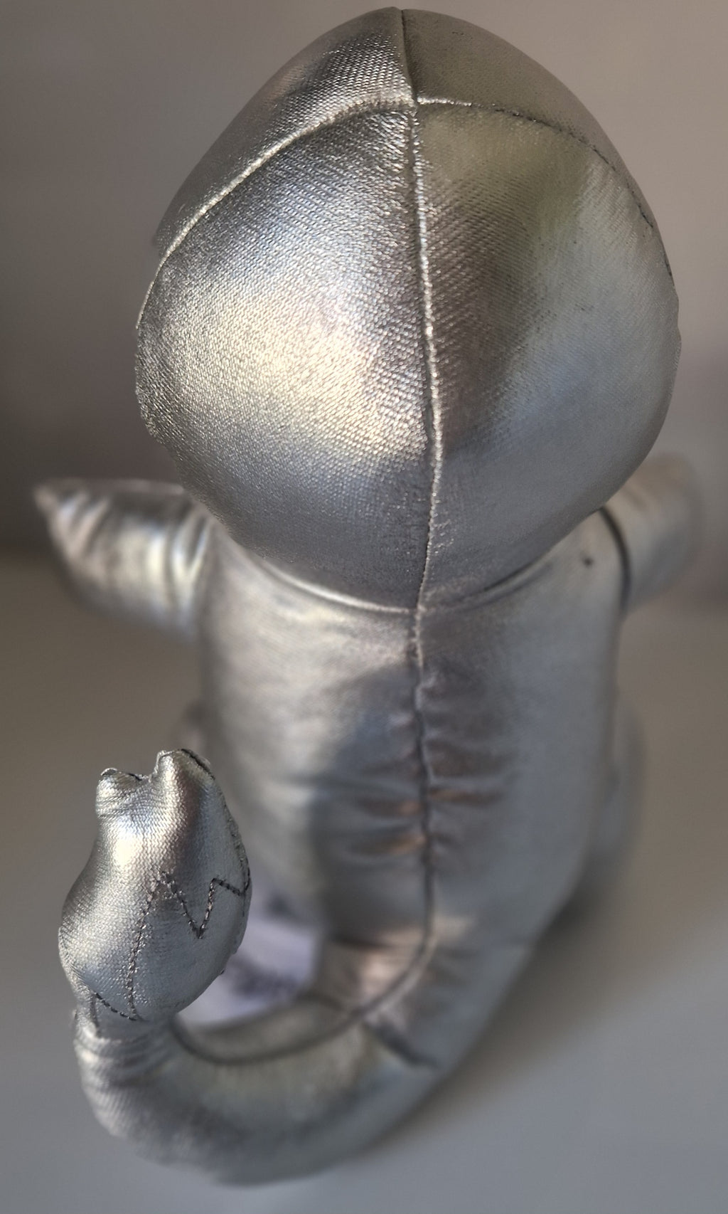 Rear view of official silver metallic Pokémon Charmander plush
