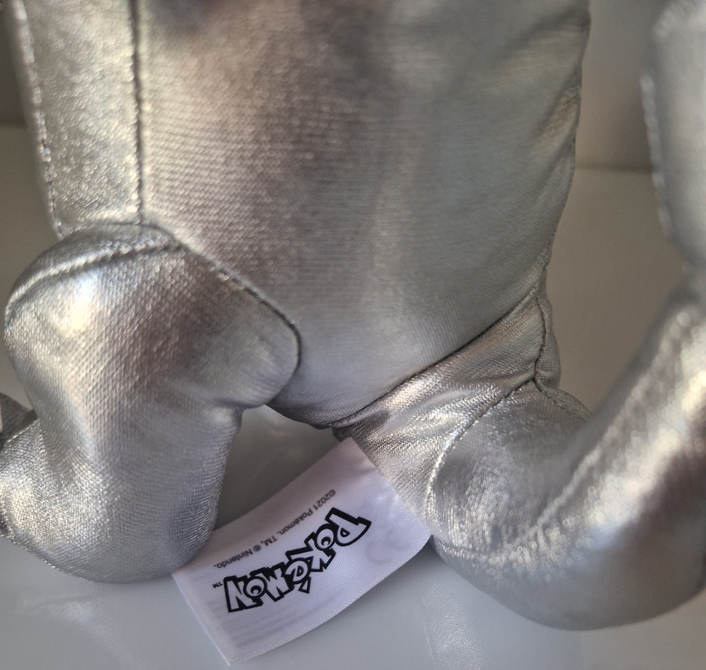 Official Pokémon label detail on silver metallic Charmander plush