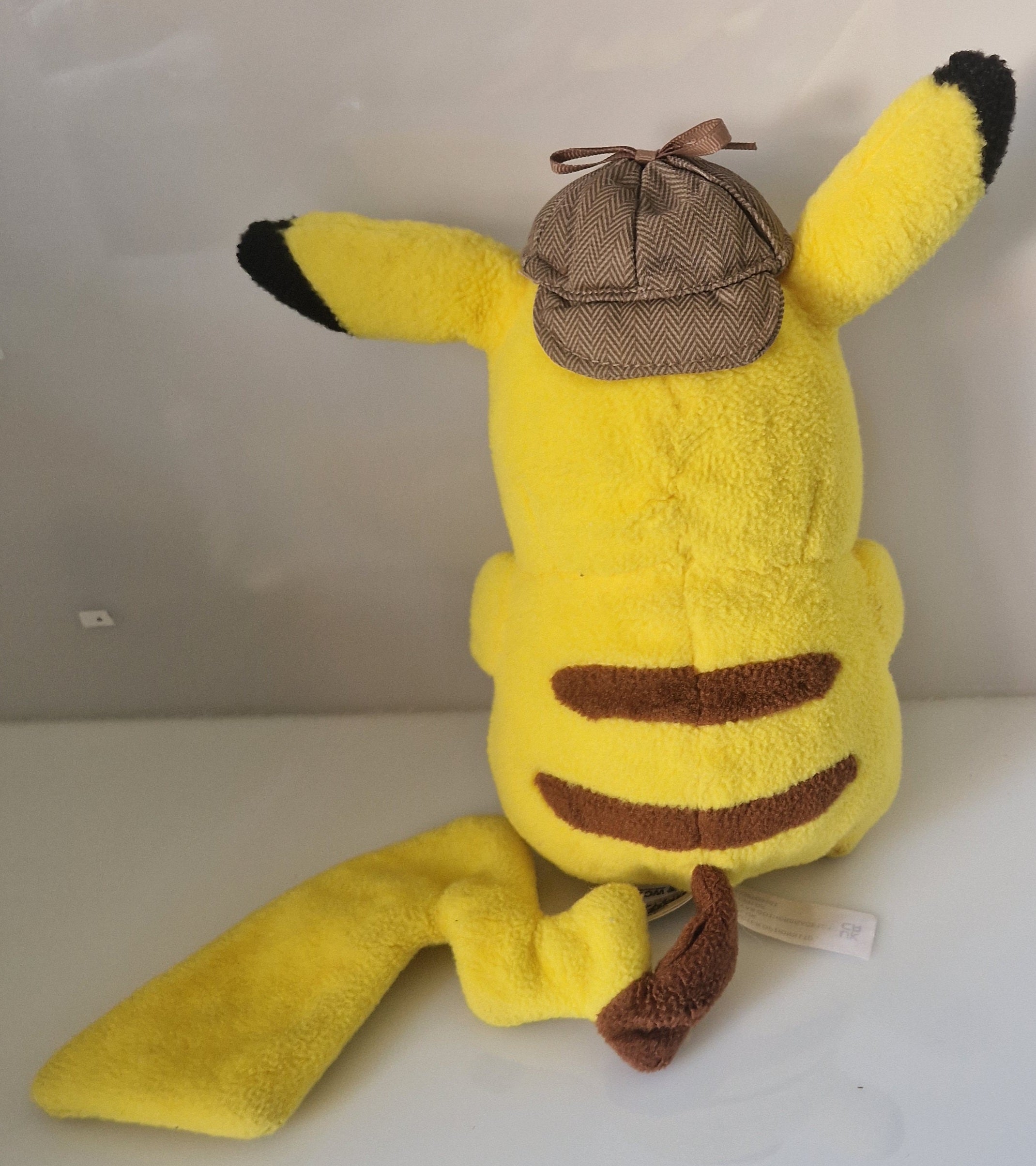 Rear view of official Pokémon Detective Pikachu plush